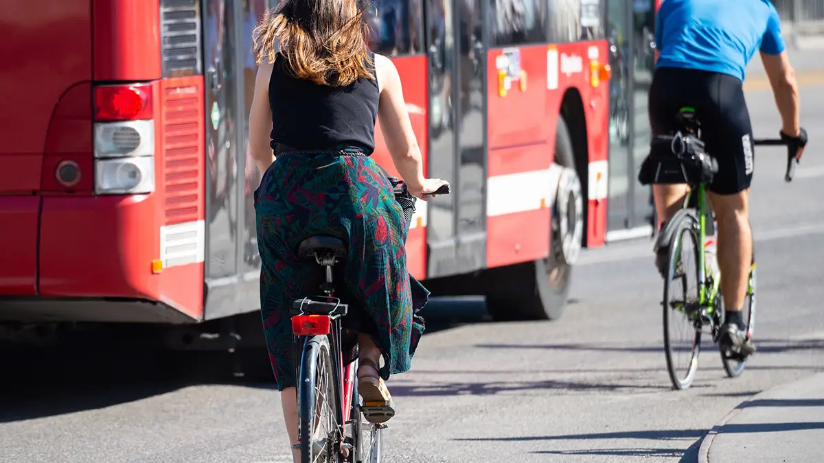 Bicyclists commuting in summer Stockholm traffic